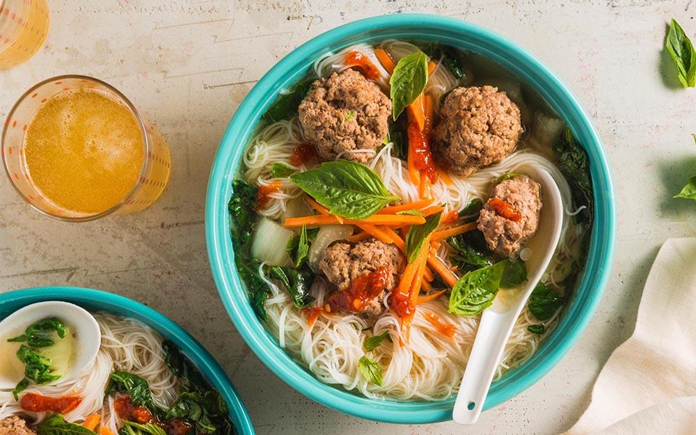 Beef Meatball Pho with noodles, Thai basil and chili sauce,